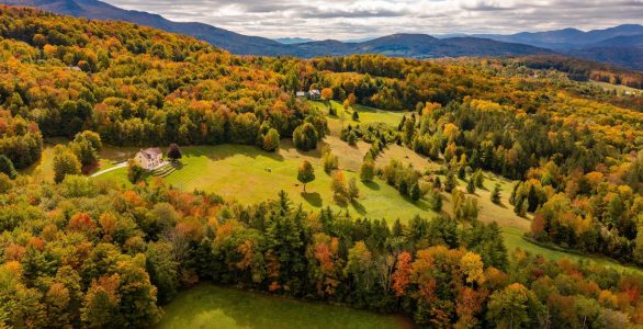 Autumn,Forest,Adorns,Isolated,Farmhouse,Under,Clouds,,Mountain,Backdrop.,Dron
